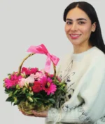 mujer con canasta de flores rosas